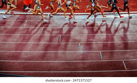 Legs of female Track and Field Athletes running on the track during professional 1500 m race. Middle distance sport photo. स्टॉक फ़ोटो