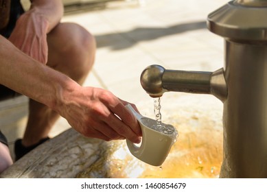 Man catching a water from hot mineral spring in Karlovy Vary in special mug Stock Photo