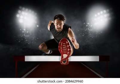 Man athlete hurdler running jumping over hurdles. Copy space background Foto stock