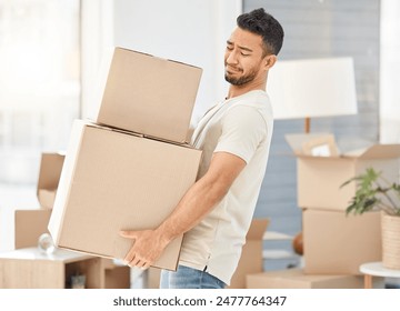 Man, boxes and house moving for property, walking with struggle or heavy cargo in apartment. Male person, carrying and cardboard container in home for real estate, difficult relocation for investment Foto stock