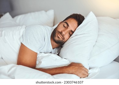 Man, sleeping and bed in morning rest for healthy wellness, peace and quiet on comfort pillow at home. Tired or exhausted male person asleep or dreaming on peaceful holiday or weekend in the bedroom Foto Stock
