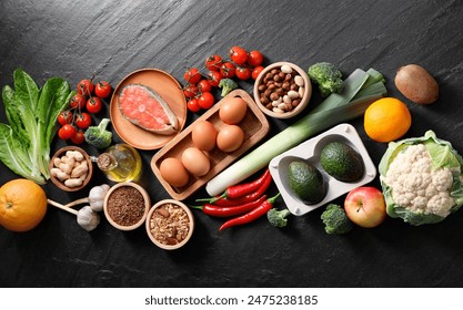 Many different healthy food on dark textured table, flat lay Foto stock
