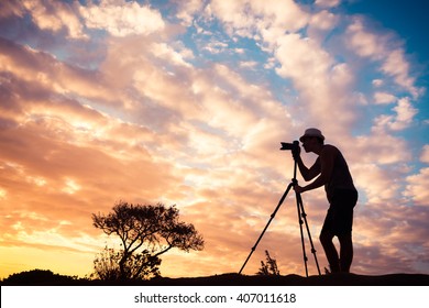 Male photographer taking photos in a beautiful nature setting.  Stock Photo