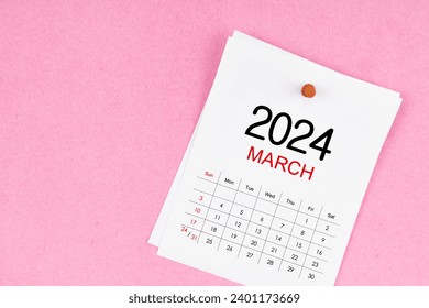 March 2024 calendar page and wooden push pin on pink Color background. Stockfoto