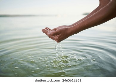 Mature woman holding water in cupped hands Arkistovalokuva