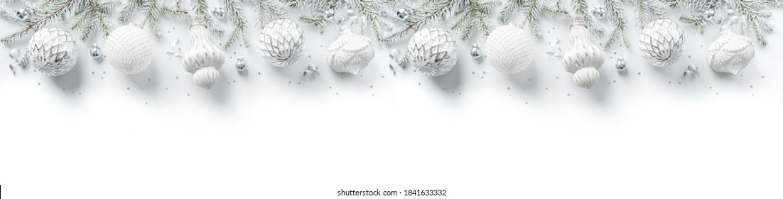 Merry Christmas wreath made of fir branches, white and silver decorations, sparkles and confetti on white background. Xmas and New Year holiday, bokeh, light. Flat lay, top view, wide banner Stock Photo