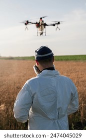 Modern technologies in agriculture. Industrial drone flies over a green field and sprays pesticides to increase productivity and destroys harmful insects. Technologies in farming Arkistovalokuva
