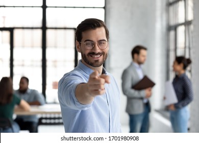 Motivated young Caucasian businessman point at screen welcome new employee or intern at office, happy millennial male boss or CEO offer suggest internship or employment, recruitment concept Stock-foto