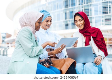 Multiethnic group of muslim girls wearing casual clothes and traditional hijab bonding and having fun outdoors - 3 arabic young girls Arkistovalokuva