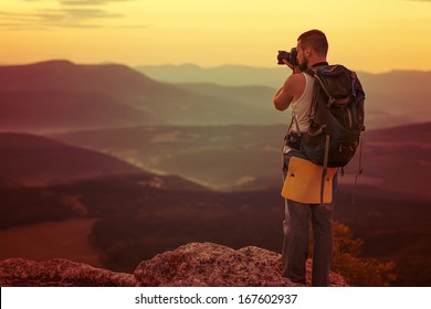Nature photographer taking photos in the mountains Stock Photo