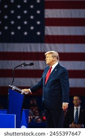 NATIONAL HARBOR, MD, USA- February 24, 2024: Donald Trump speaks at an event about his plan for defeating current President Joe Biden in November. Toimituksellinen arkistovalokuva