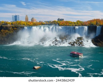 Niagara Falls. A pleasure boat with people near the huge famous waterfall. View from the Canadian side. Nature scenery. Photo for advertising. Arkistovalokuva