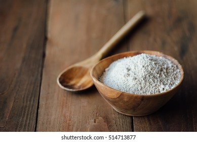 Oat flour in old wooden bowl on dark wooden background Stock Photo