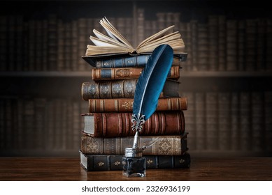 Old books ,quill pen and vintage inkwell on wooden desk in old library. Ancient books historical background. Retro style. Conceptual background on history, education, literature topics.
 Stock-foto