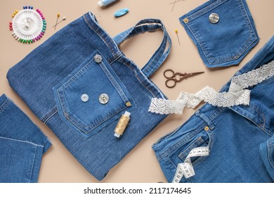 Old jeans and denim bag with sewing accessories. Top view. Recycling concept. Crafting with denim. Stock Photo
