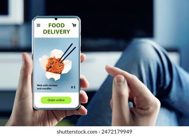 Order and deliver food online. Eat from smartphone. Gadget on blue background. fast food and fast delivery when ordering online concept. order a meal in a restaurant using the app on mobile phone 库存照片