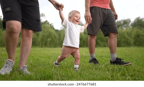 Parents and baby walking in the park. Hug stroller step concept. Family with baby walking in nature. Parents and their children walking fun in nature in the. park. happy childhood concept. – Ảnh có sẵn