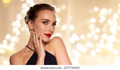 people, luxury and beauty concept - beautiful woman in black with red lipstick over beige background and festive lights – Ảnh có sẵn