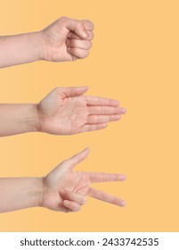 People playing rock, paper and scissors on pale orange background, closeup Stock-foto