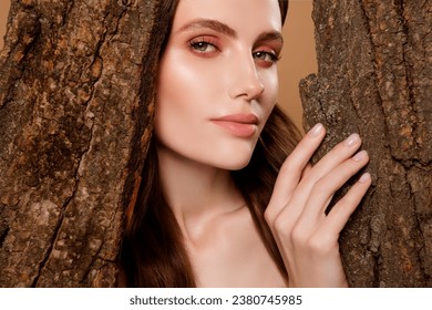 Photo of mysterious stunning lady hide from tree in magical woods nature princess on pastel color background Stockfotó