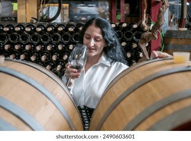 Portrait girl woman caucasian celebrating smile happy enjoying people bar hand holding drink taste in glass wine and red wine bottle together with walk visit in wine factory warehouse beverage – Ảnh có sẵn