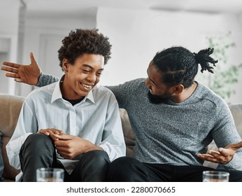 Portrait of a happy teenage boy son talking to his father at home. Sharing secrets and having fun, support and parenthood concept Foto stock