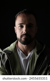 Portrait of man in studio with black background and half face wi Stockfoto
