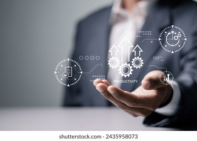 Process to increase productivity concept. Businessman holding productivity icon on virtual screen for industrial management in efficiency and efficient process. Lean cost and productivity growth.  Stock-foto