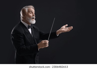 Professional conductor with baton on black background Stockfoto