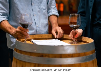 Professional Caucasian man and woman sommelier winemaker tasting and smelling red wine in wine glass at wine cellar or liquor shop. Winery, brewery manufacturing factory industry and business concept. – Ảnh có sẵn