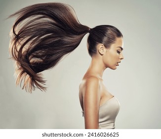 Profile portrait of a beautiful woman with a long  hair. Young  brunette model with  beautiful hair - isolated on white background. Young girl with straight hair flying in the wind.   Stock Photo