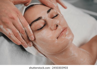 Qualified beautician cleansing caucasian man's face before beauty procedure at spa salon. Skincare cleansing spa relax concept Stockfotó