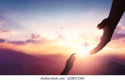 Religion and salvation concept:God reaching out to help people on cross background Stock Photo