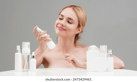 Skin Care, Woman advertises Set of different cosmetic white bottles of cream, serum, spray for skin care routine. Cosmetics packaging. Natural beauty product concept. Mock-up. Advertising, cosmetology Stockfotó