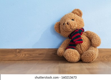 Single teddy bear on a floor in a child room Stock Photo