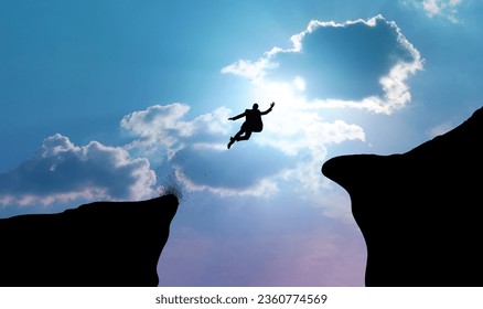 Silhouette of businessman leaping or jumping across two cliffs. Business concepts of decision-making, courage, and risk-taking for success. Foto stock