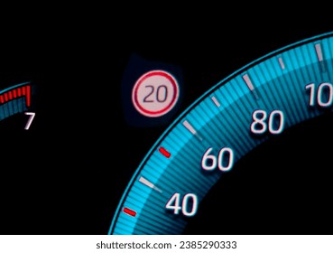 Speed limit warning close to speedometer indicator. Digital car dashboard closeup Stockfoto