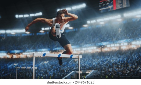 Strong Male Athlete is Running Towards an Obstacle, Hurdling, Jumping Over the Barrier in Front of a Stadium of Cheering Fans while Sprinting in a Race. Shot Of Professional Sports Performance. स्टॉक फ़ोटो