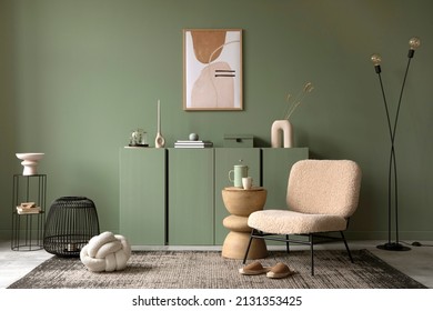 Stylish living room interior design with mock up poster frame, frotte armchair, wooden commode, side table, plants and creative home accessories. Sage green wall. Home staging. Template. Copy space. Stock-foto