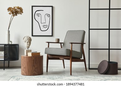 Stylish scandinavian composition of living room with design armchair, black mock up poster frame, commode, wooden stool, book, decoration, loft wall and personal accessories in modern home decor. Stock Photo