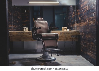 Stylish Vintage Barber Chair In Wooden Interior. Barbershop Theme Stock Photo
