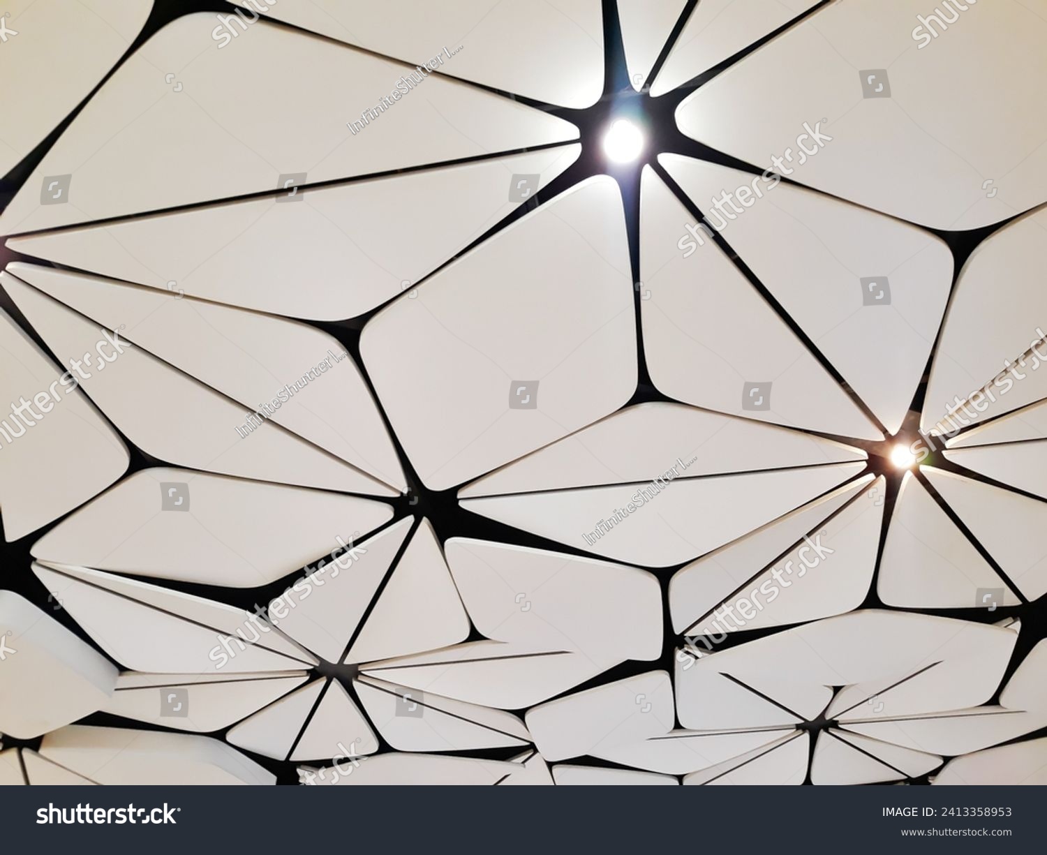 Beautiful acoustic ceiling panel. White decorative ceiling board i a building with lighting rays.