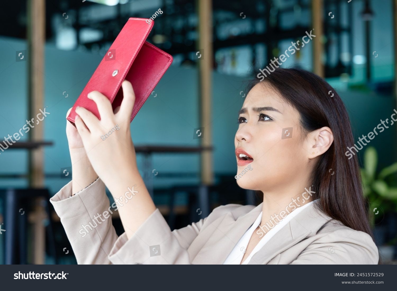 Sad and unhappy office worker woman or business woman having no money, concept of indebted debt with no money, economic recession, joblessness, unemployment, layoff, financial problem, empty wallet