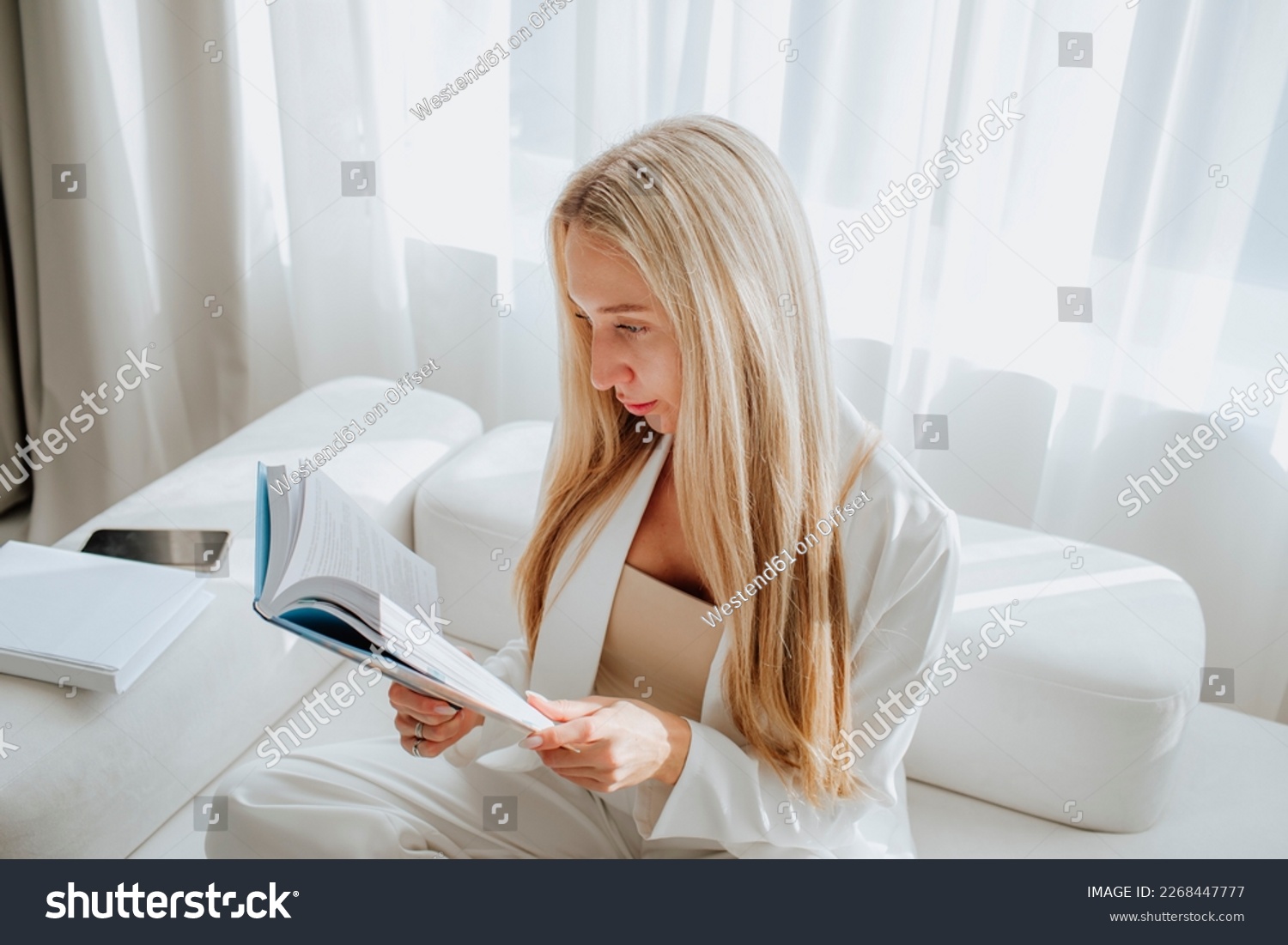 Young psychologist reading book in clinic