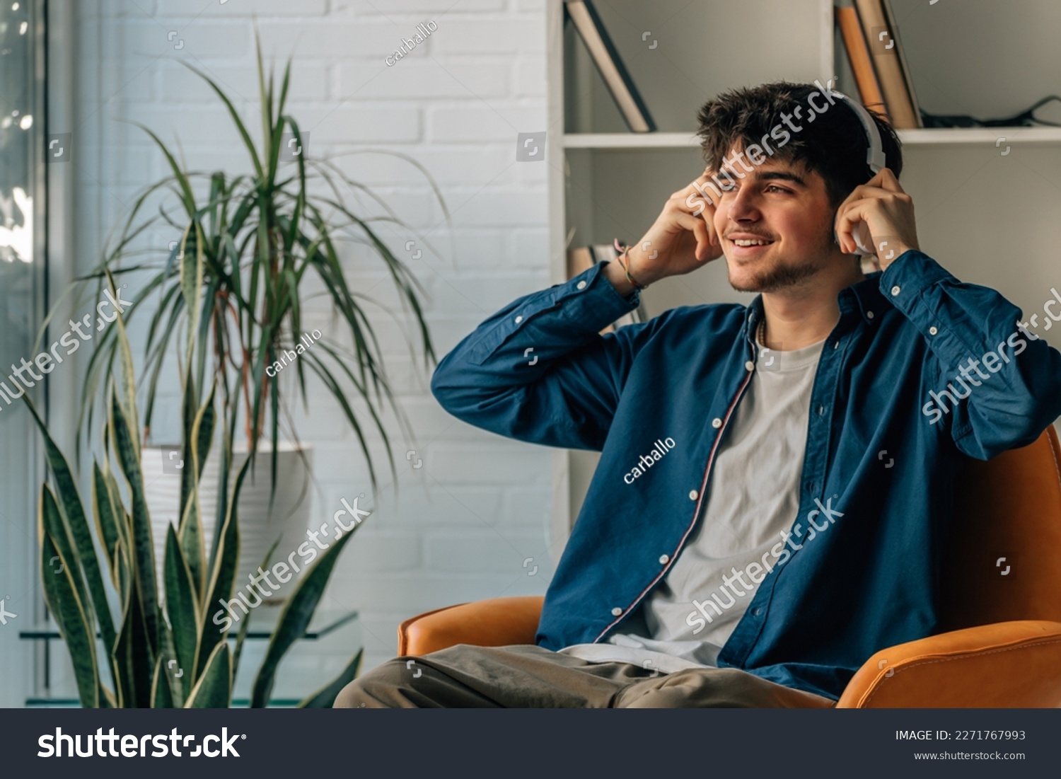 young man at home with headphones