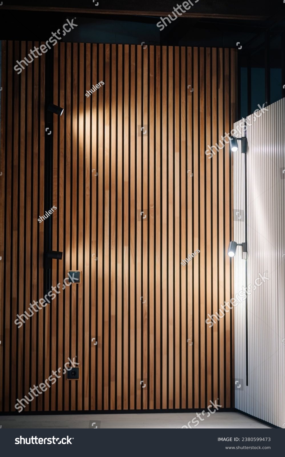 Acoustic panels background wooden beams modern background. Black outlet plug and light switch.
