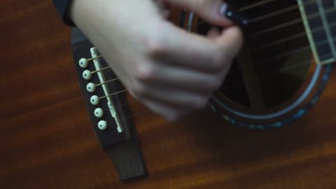 Young woman's hand, strumming the guitar Arkistovideo