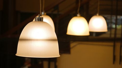 Vintage Old Lights Bulbs Lighting Decoration in Retro Classic Style. Old School Lights Hanging on Ceiling in Cafe. Light in the dark. 4K.の動画素材