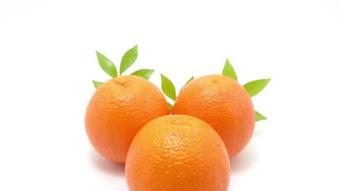 Fresh orange fruit with green leaf on the white background , Panning shot , 4K 库存视频