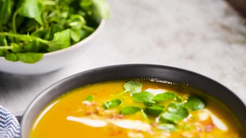 Стоковое видео: Healthy Pumpkin soup with cream and organic pumpkin seeds.